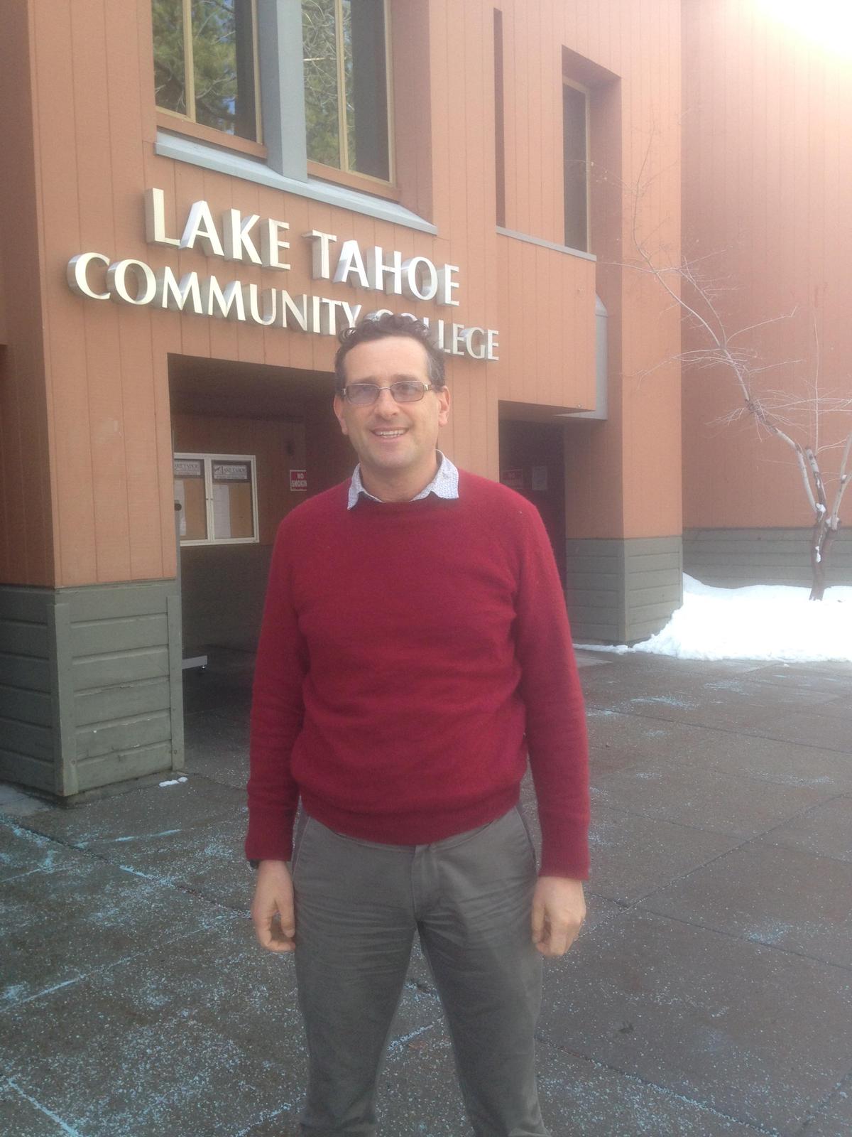 man in a red sweater standing outside of Lake Tahoe Community College